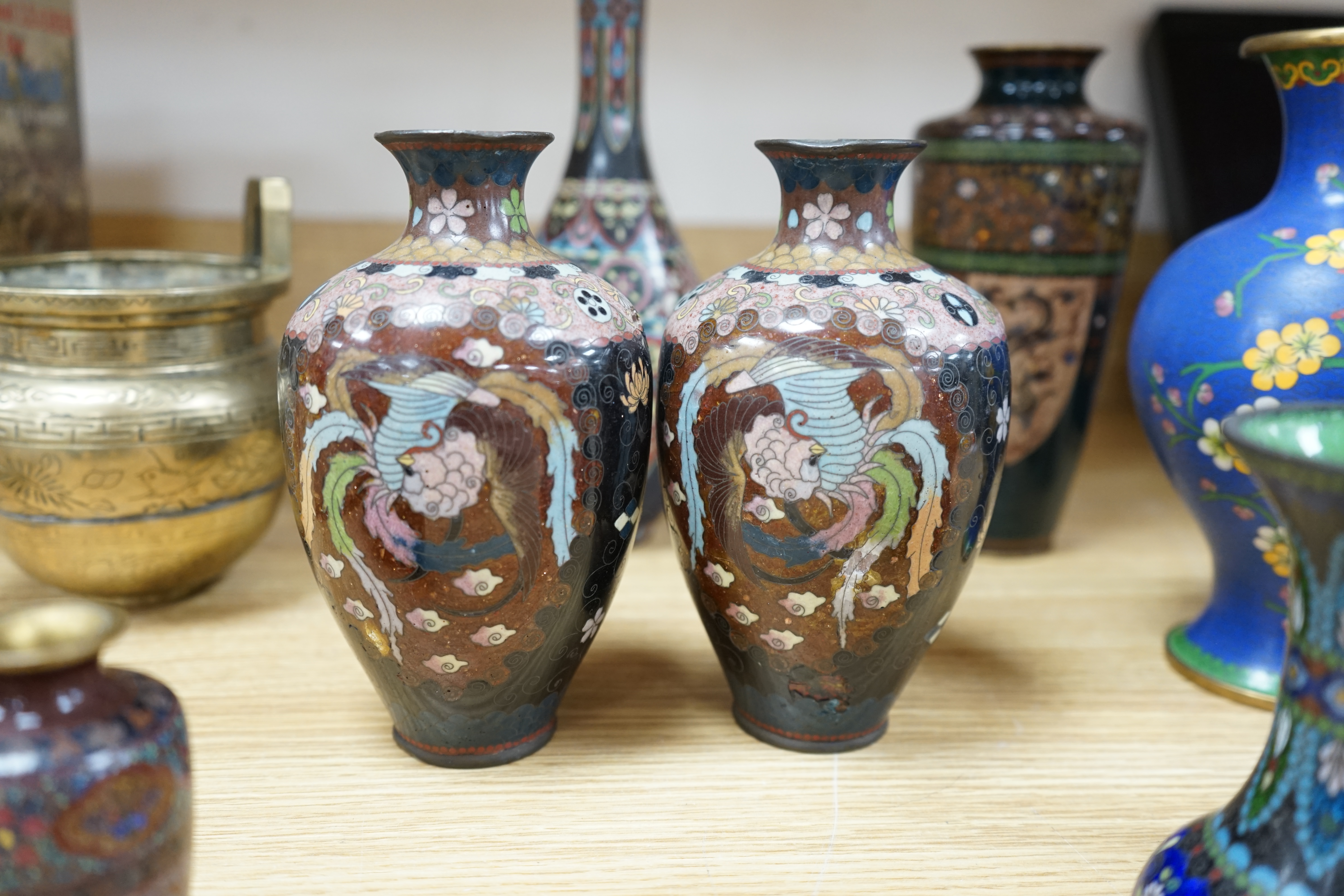 A large collection of Chinese and Japanese cloisonné vases and a brass twin handled censer, largest 31cm high. Condition - mostly poor to fair